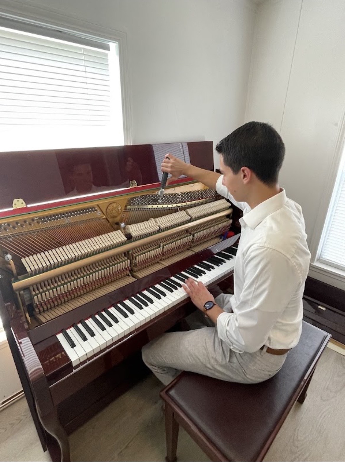Phillip working on an upright piano